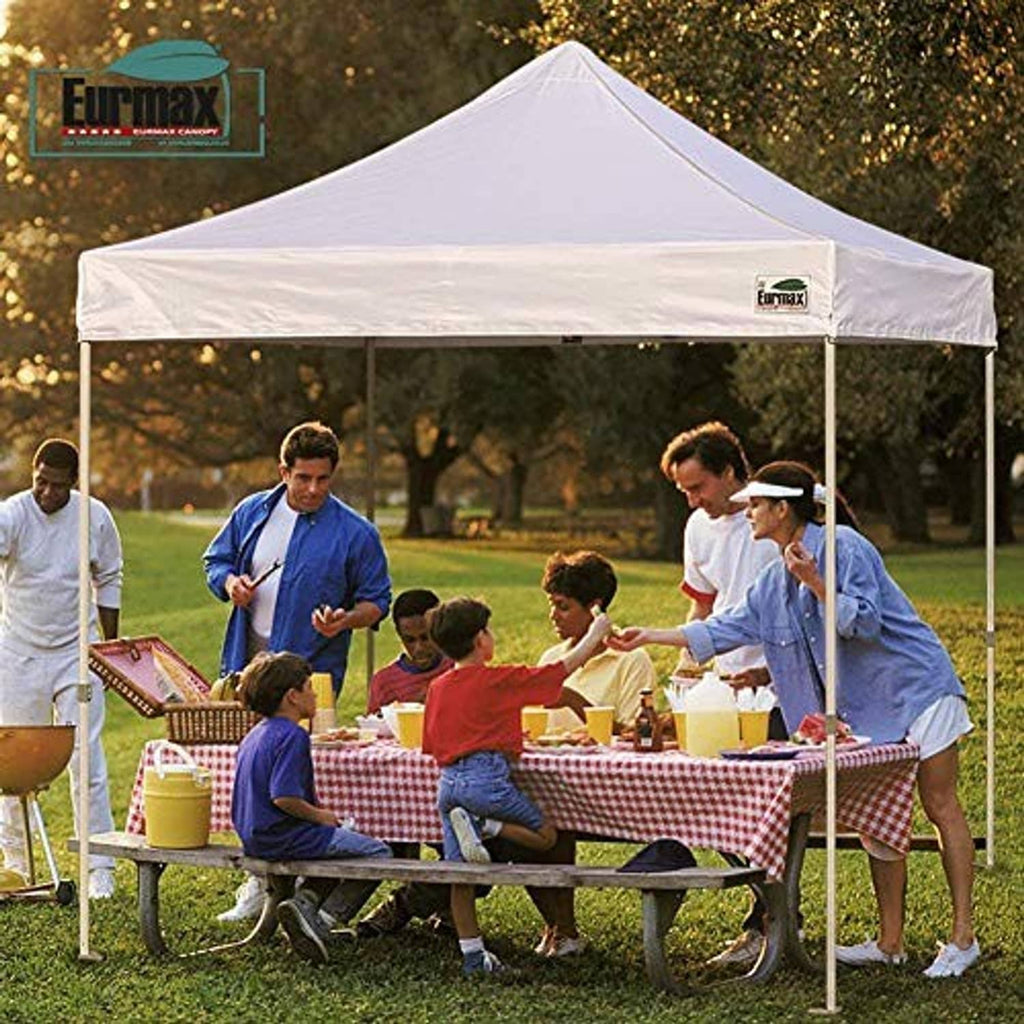 White pop-up canopy with valance logo panel at outdoor picnic