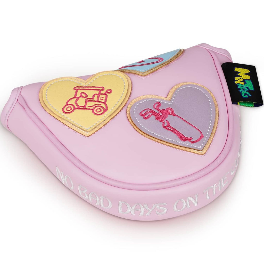 Pink mallet putter cover with embroidered heart patches and stitched edging.