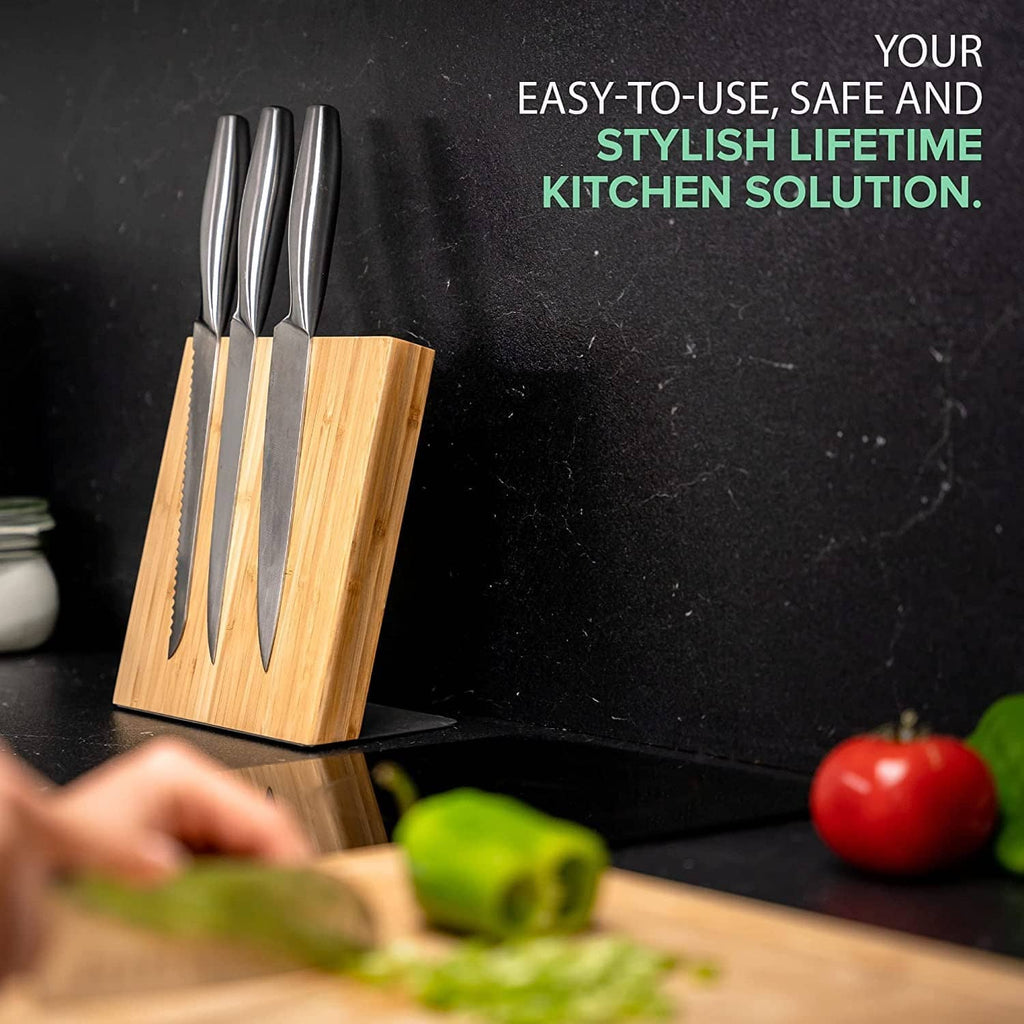 Coninx magnetic knife holder with knives standing in bamboo block on kitchen counter