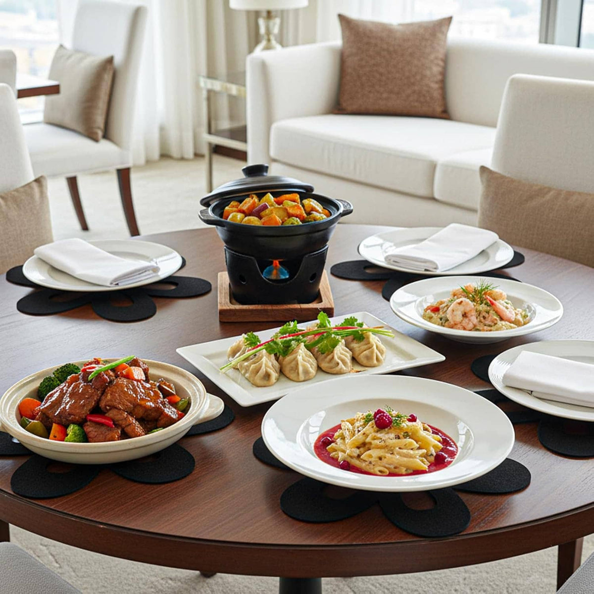 Black flower felt liners placed under serving dishes on round dining table