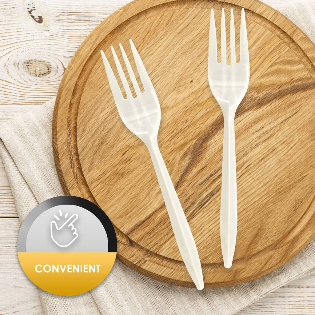 White disposable plastic forks on a round wooden serving tray