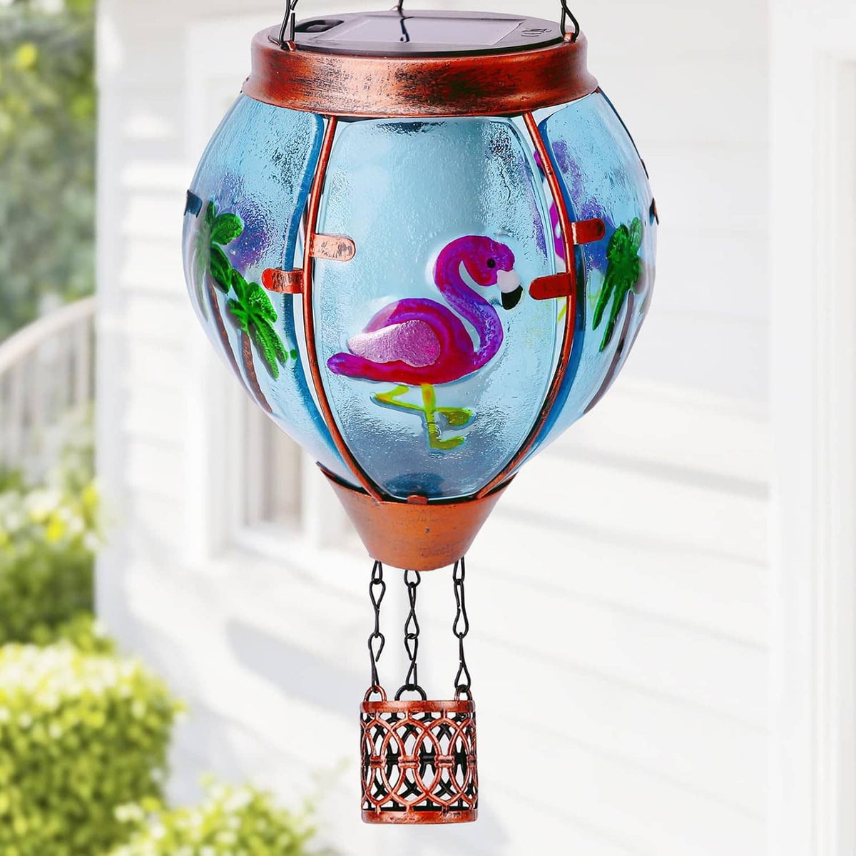 Blue glass hot air balloon lantern with flamingo artwork and metal hanging light frame