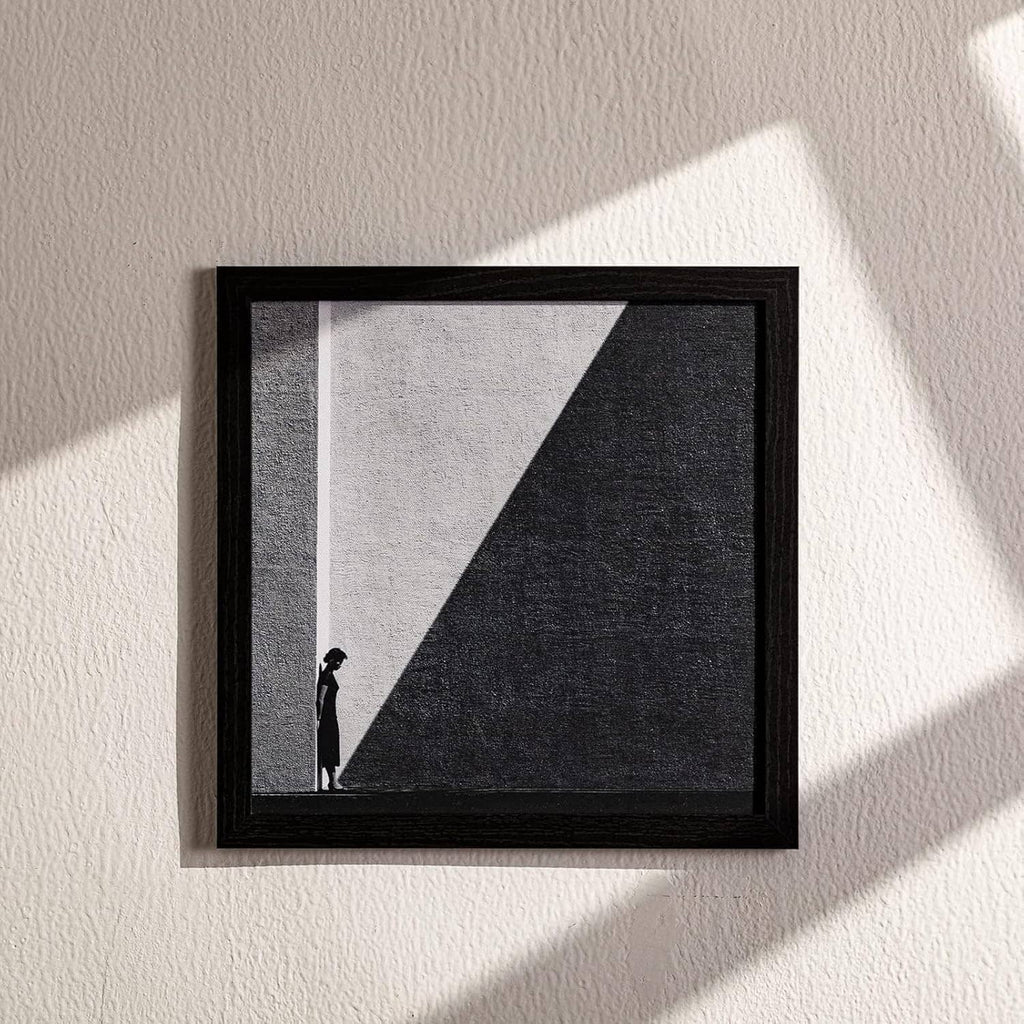 Black 12x12 picture frame with geometric black-and-white print on a wall.