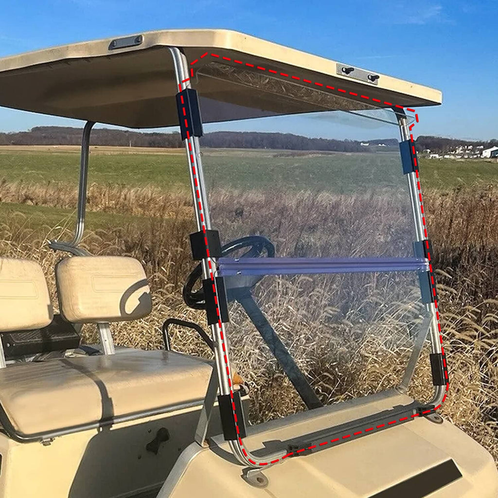 Clear folding windshield with black frame in side view on a beige golf cart