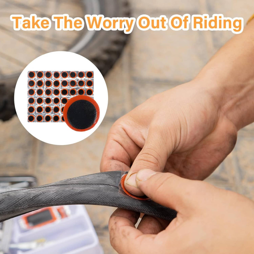 Hand applying a round black rubber tire patch to a bicycle inner tube area