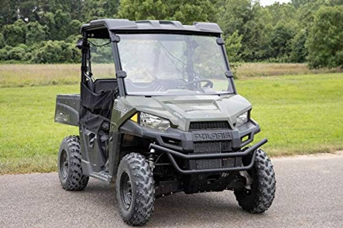 Side view of full windshield with black frame on a utility side-by-side