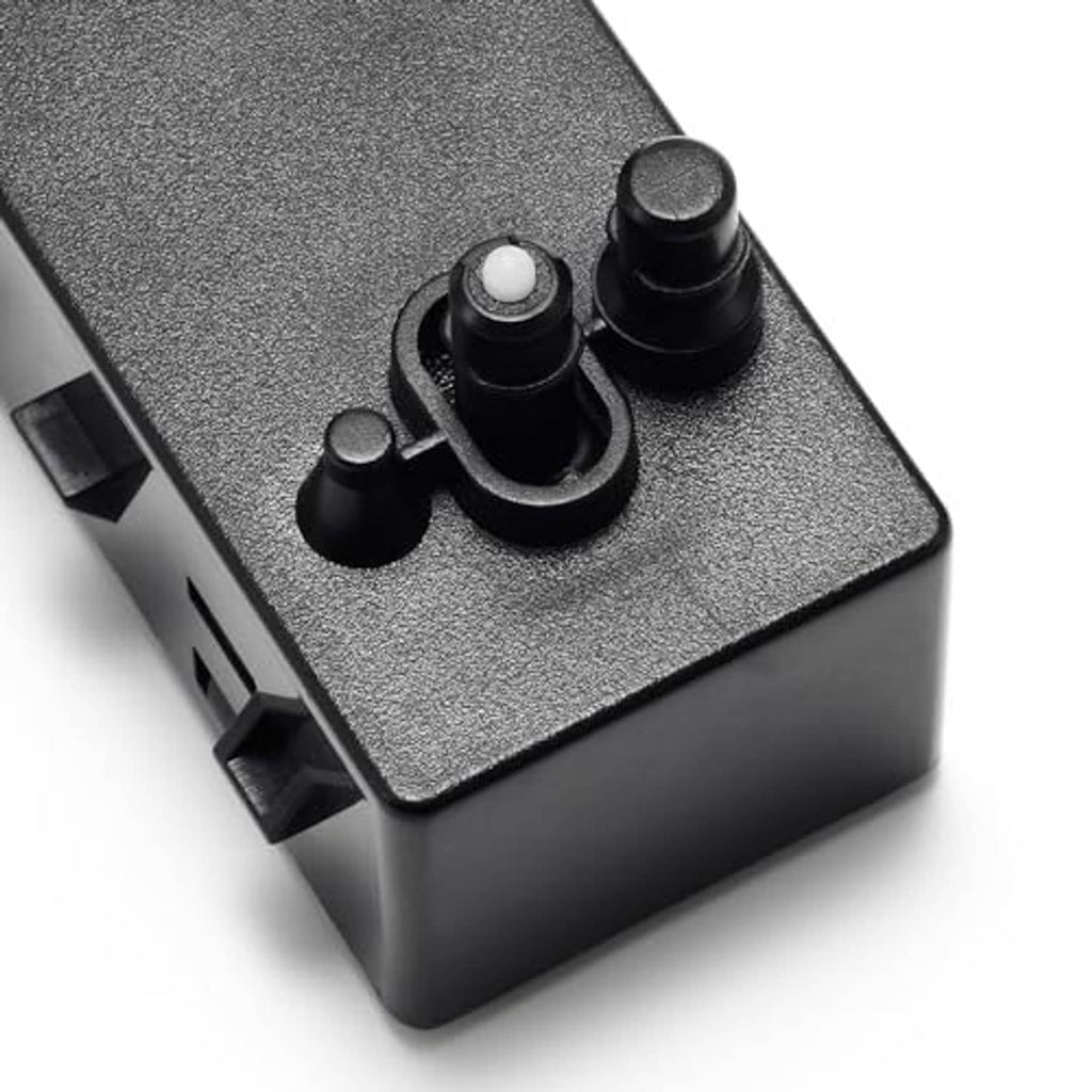 Close-up of power seat switch controls with textured dark gray housing