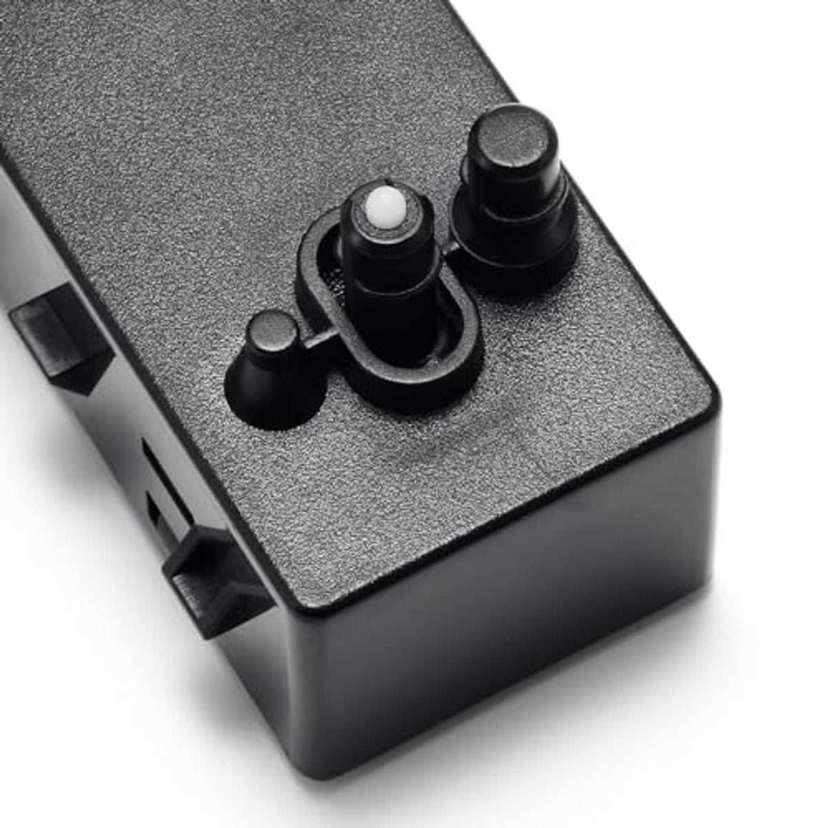 Close-up of power seat switch controls with textured dark gray housing