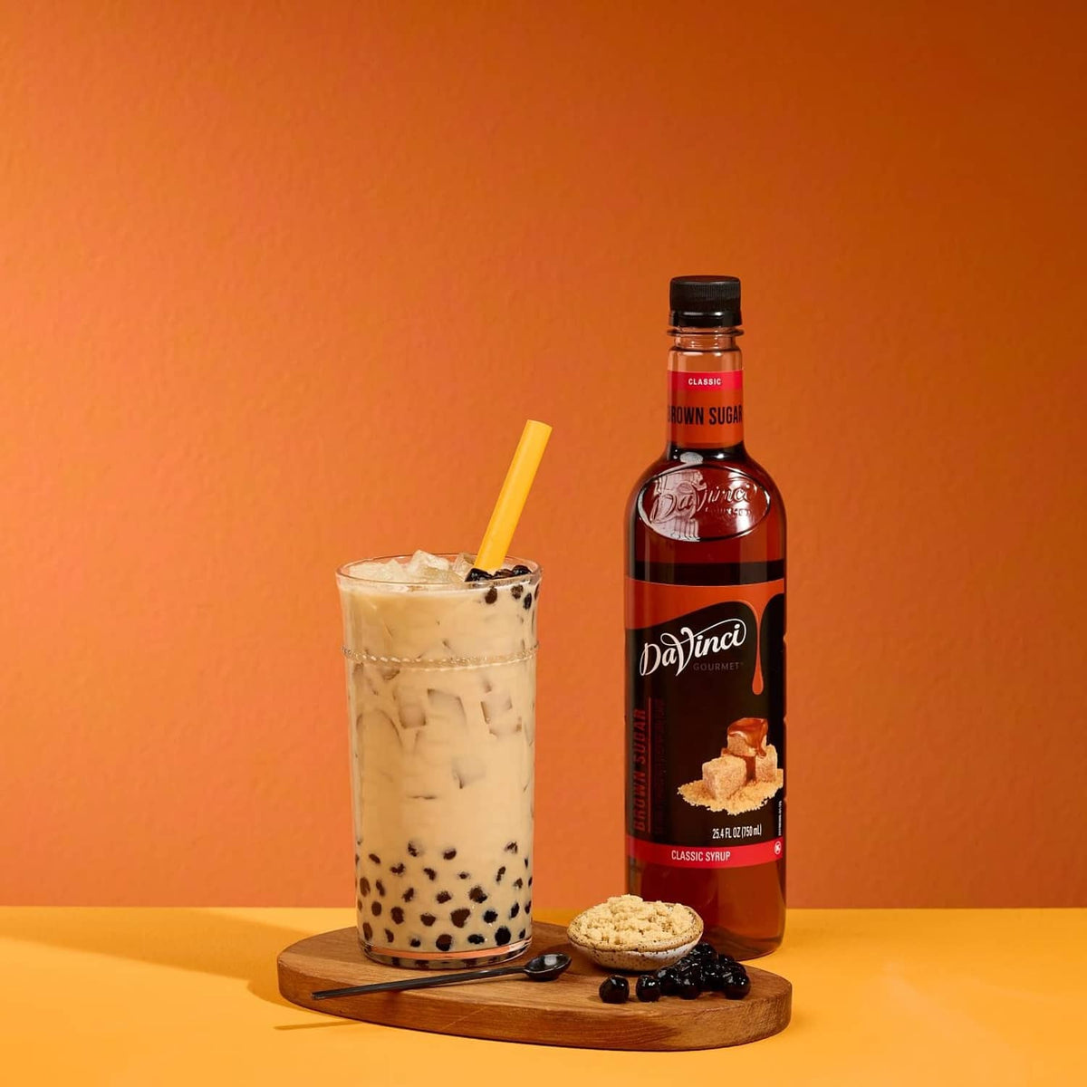 DaVinci Gourmet brown sugar syrup bottle with iced drink in glass and sugar cubes