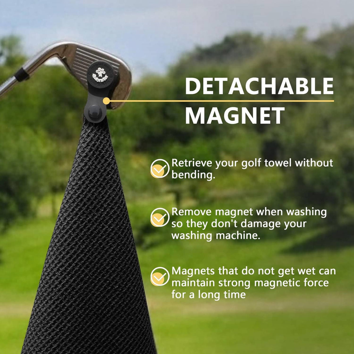 Black golf towel secured to a golf club with a detachable magnet