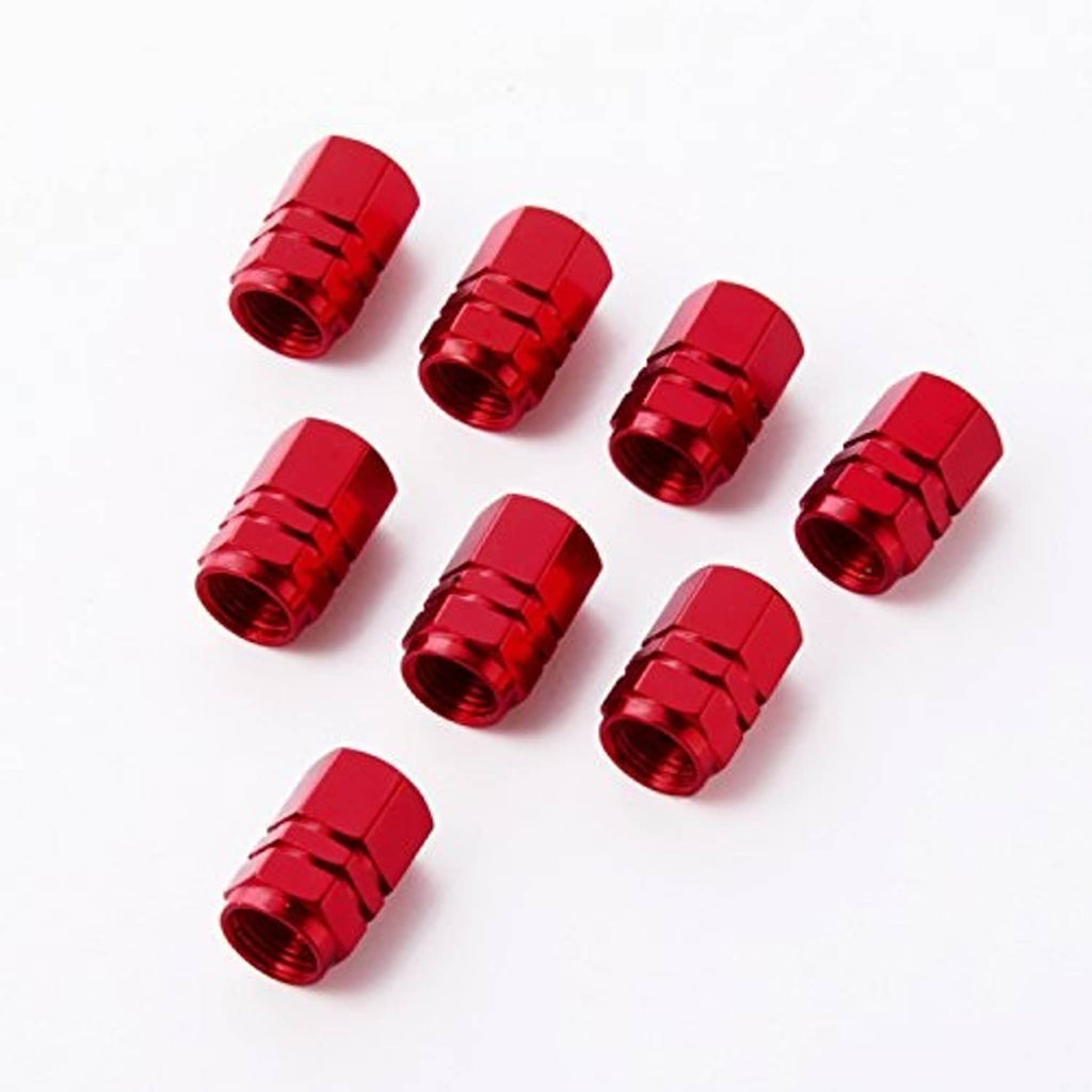 Eight red tire valve stem caps laid out, hex top and ridged metal sides