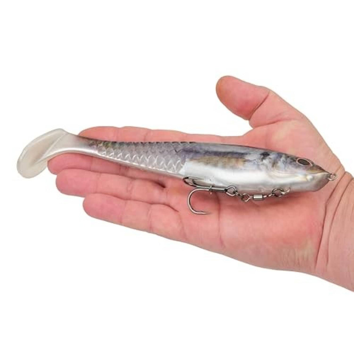 Soft plastic swim bait held in hand, silver-blue body with dark top and treble hook