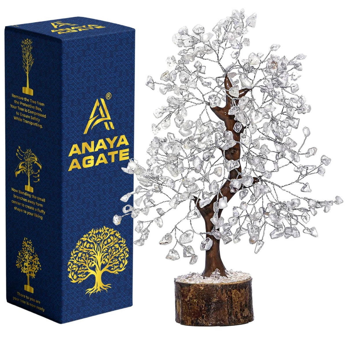 Clear quartz crystal tree with wooden base, displayed next to a blue gift box
