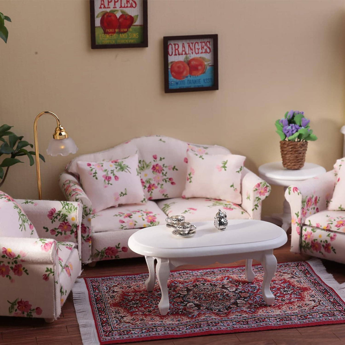 Floral dollhouse sofa set with loveseat and two armchairs surrounding a white round table