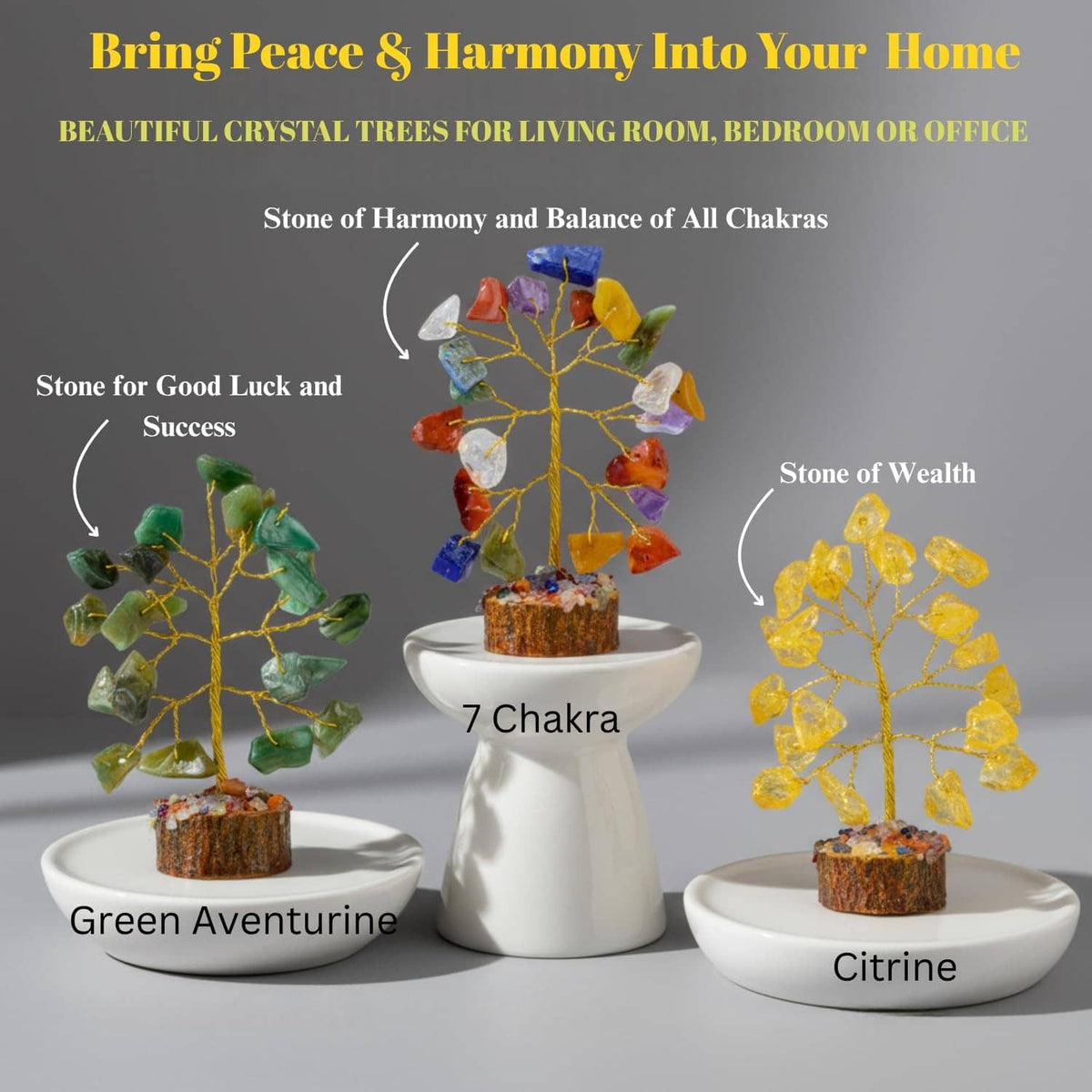 Three chakra gemstone crystal trees on white pedestal stands with colorful stone branches.