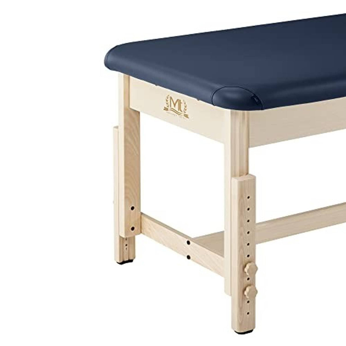 Stationary treatment table with dark blue padded armrest and light wood frame