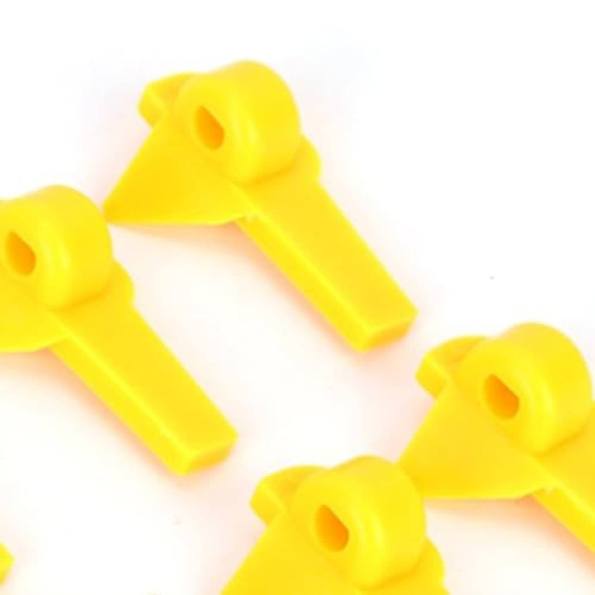 Yellow tire changer demount head protector tips close-up, molded plastic pieces