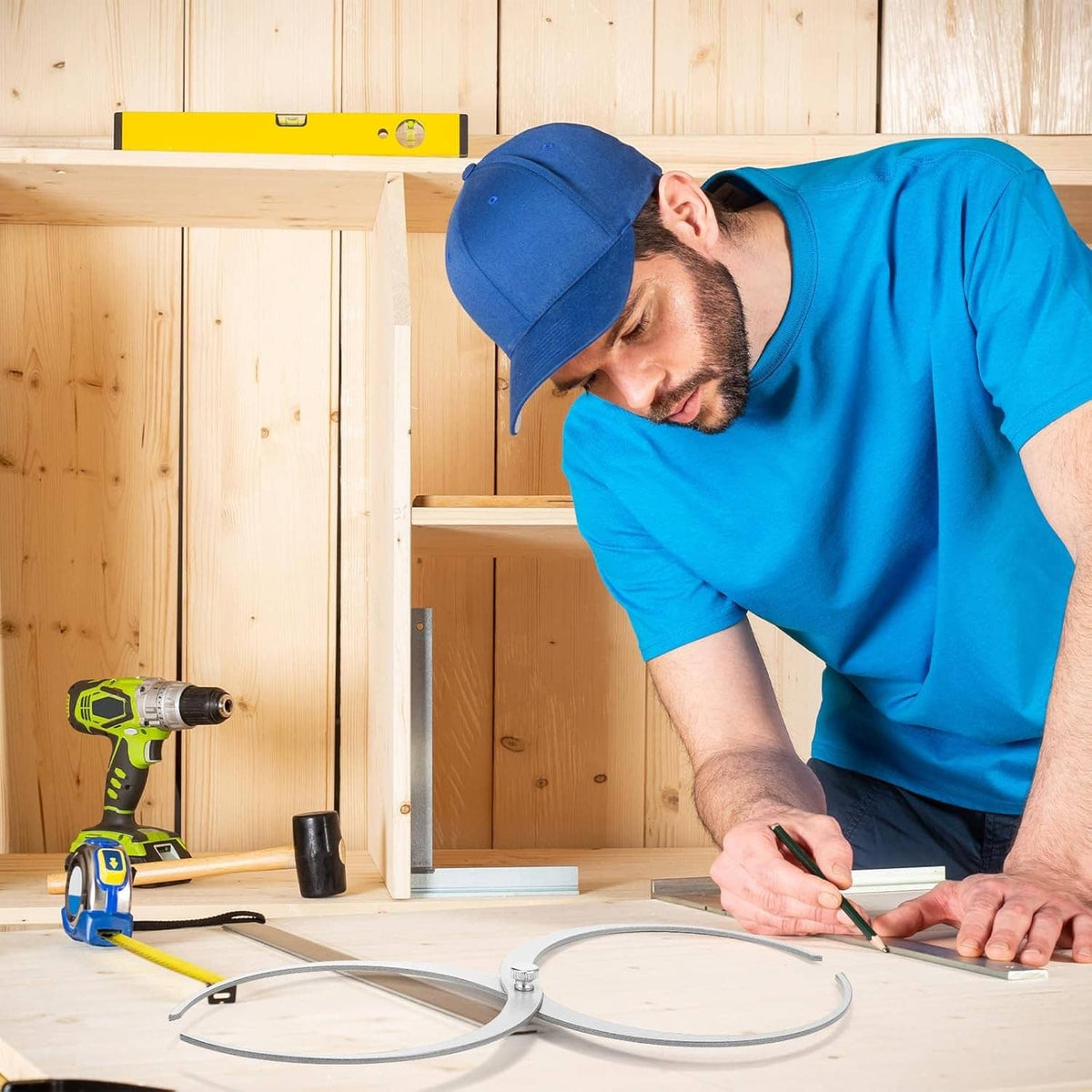 Wood turning caliper gauge with two metal measuring rings on worksite surface