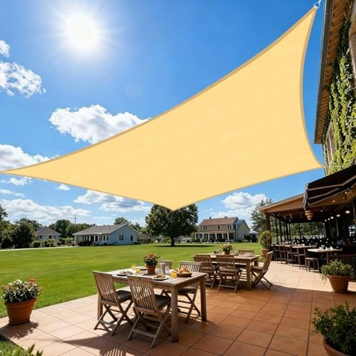 Sand beige rectangle sun shade sail with curved corners, covering patio seating area.