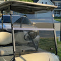 Tinted folding golf cart windshield with clear panel and black metal frame installed