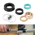 Pump repair kit parts set with black seals, teal gasket, brass bushings, and steel ball