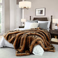 Brown faux fur blanket with black tips, long pile, draped on a bed