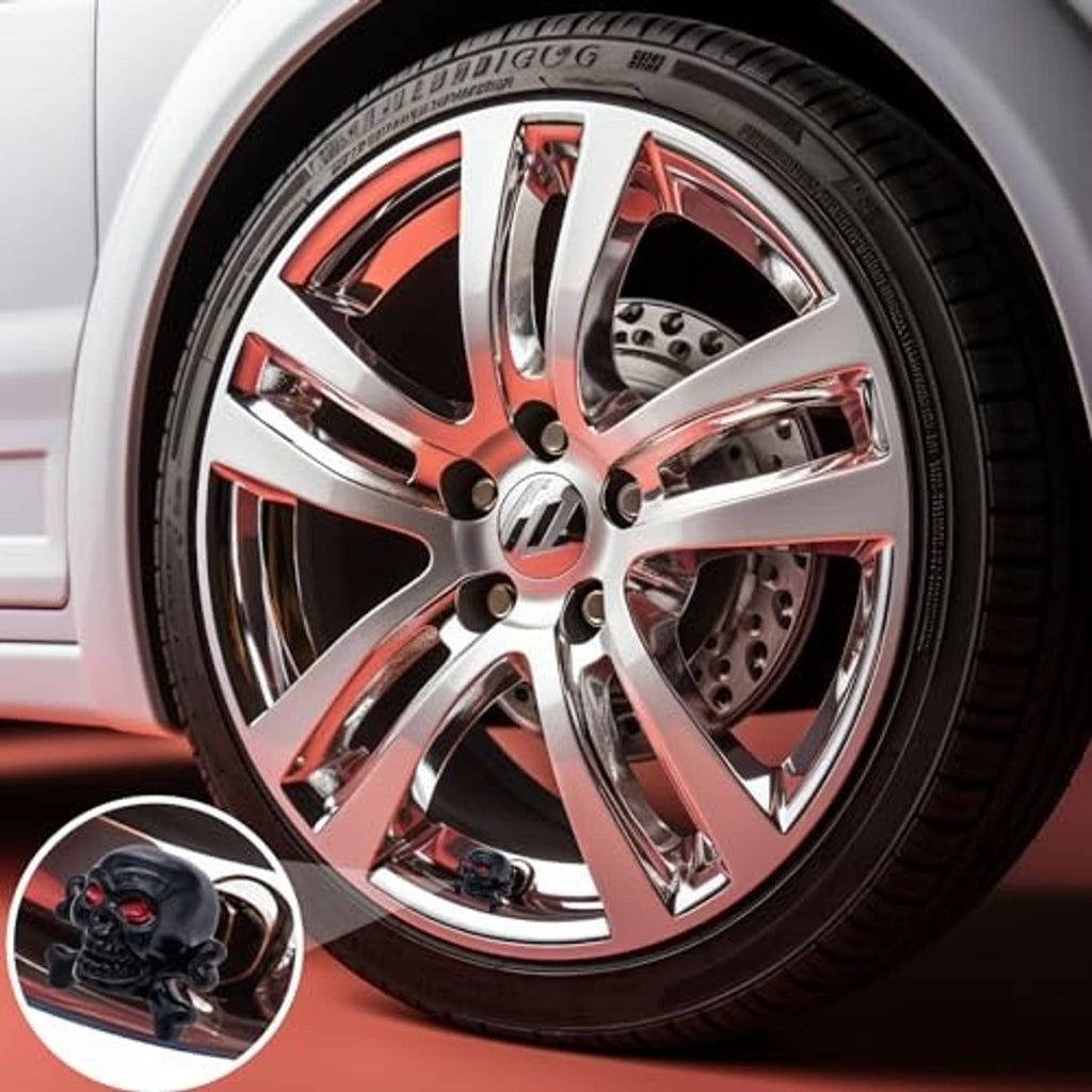 Black skull tire valve stem cap on a chrome and red alloy wheel