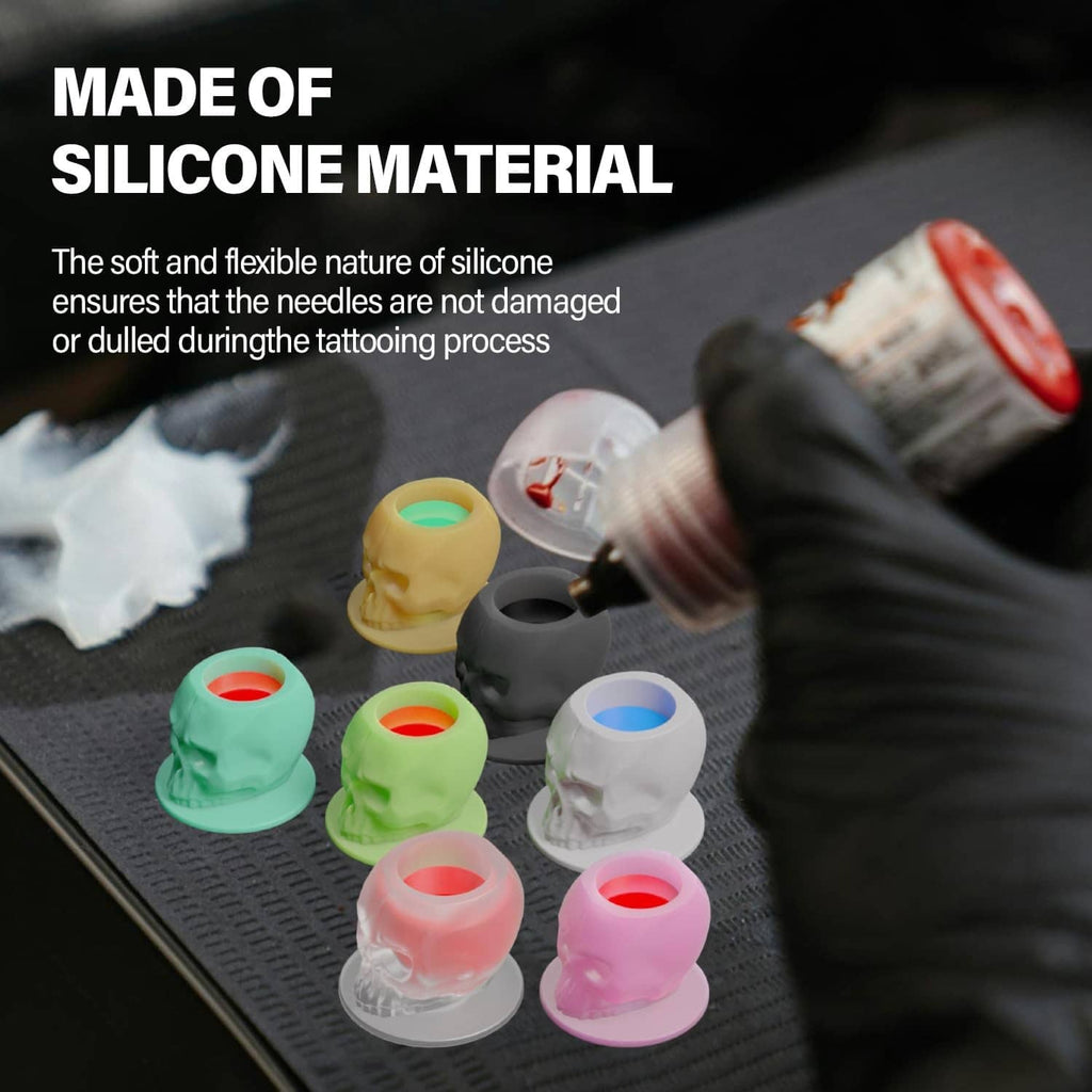 Silicone tattoo ink cups with skull-shaped bases and open ink wells in multiple colors.