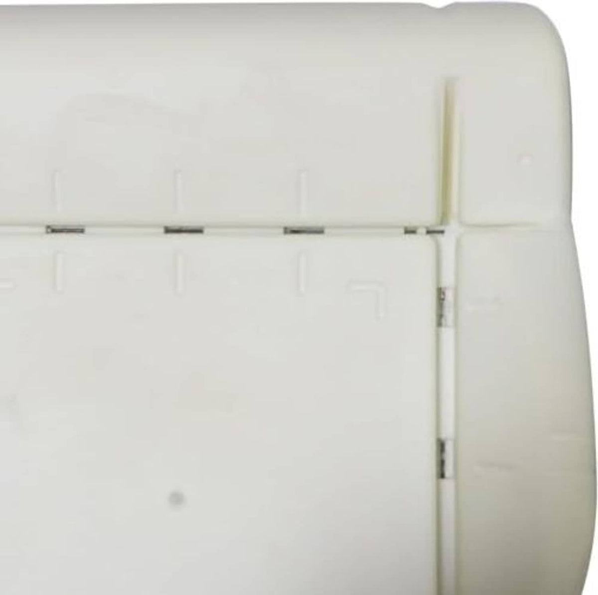 Close-up of light beige seat foam pad edge and seam with embedded metal hardware