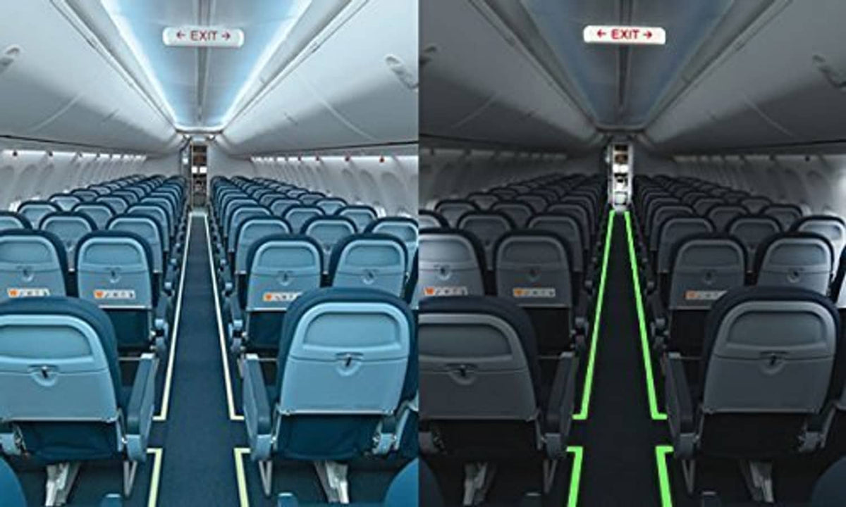 Glow-in-the-dark tape accents on airplane cabin handrails, forming bright green lines