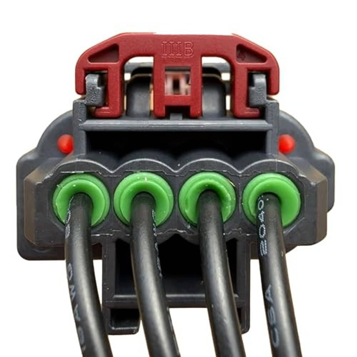Throttle body sensor connector showing green terminal pins in red and black housing