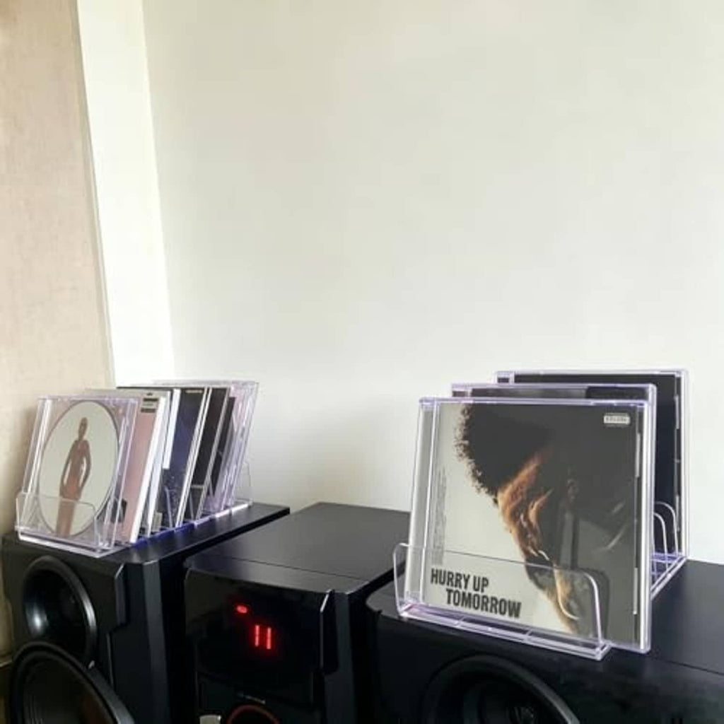 Clear acrylic CD holder displaying CDs inside a 7-slot organizer tray