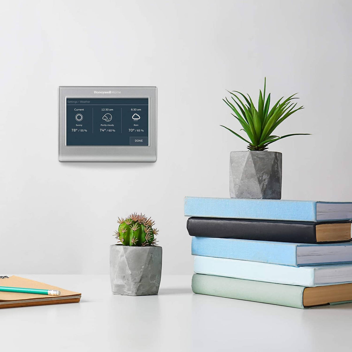 Gray wall-mounted Honeywell smart thermostat with touchscreen and status icons