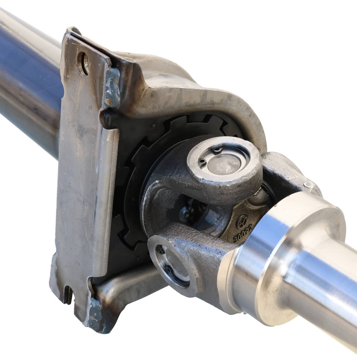 Rear drive shaft assembly close-up of U-joint housing and steel flange