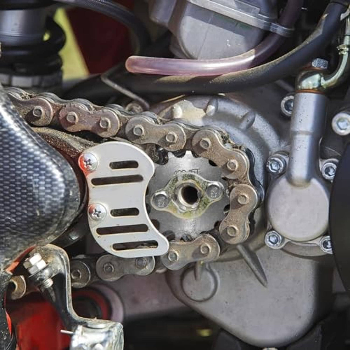 Front engine sprocket with drive chain and mounting area on motorcycle engine
