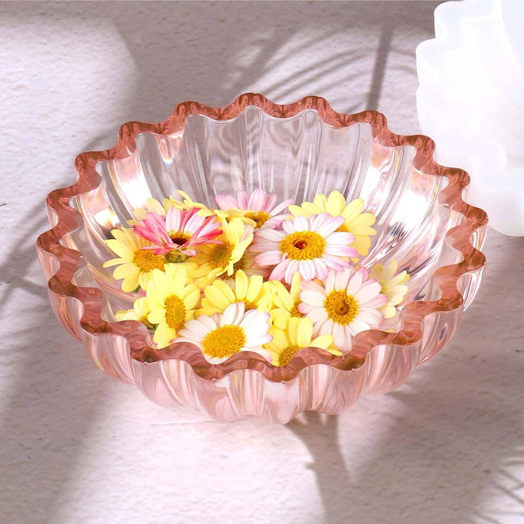 Pink translucent resin bowl with scalloped rim and yellow, pink, and white flowers