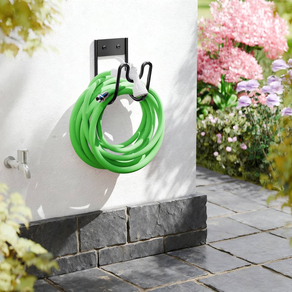Black wall-mounted hose holder with two hooks holding a loop of green garden hose