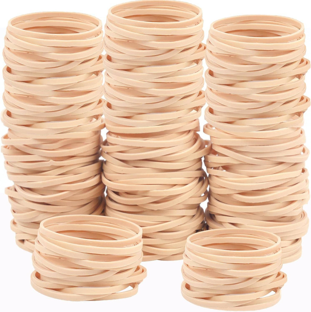 Beige elastic rubber bands stacked in three columns with two loose rings at front