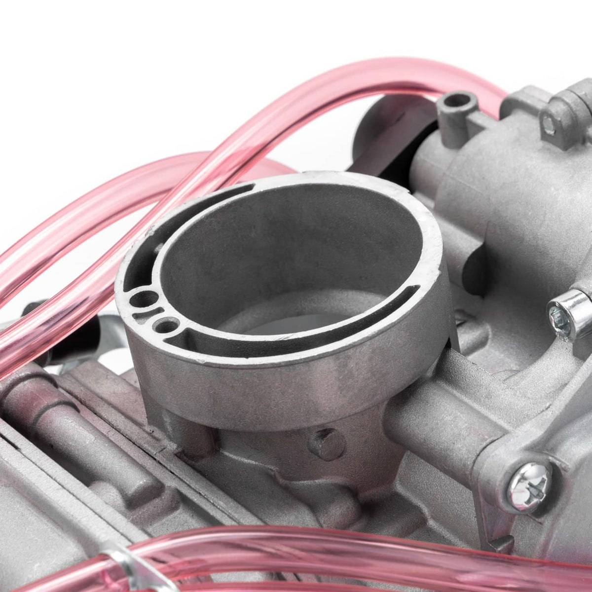 Close-up of carburetor intake throat on gray housing with pink fuel line connections