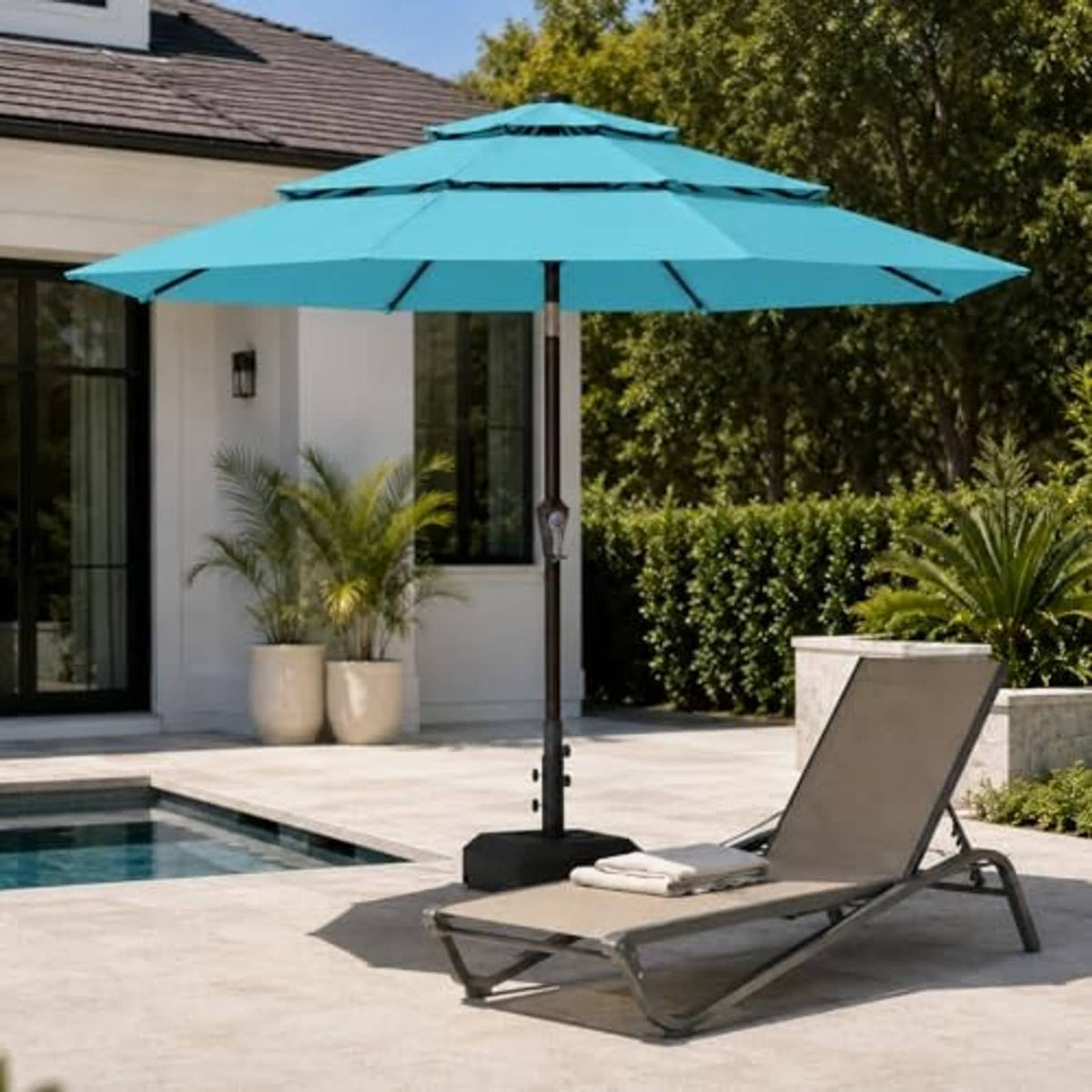 Sky blue 3-tier vented patio umbrella with center pole and open canopy over seating