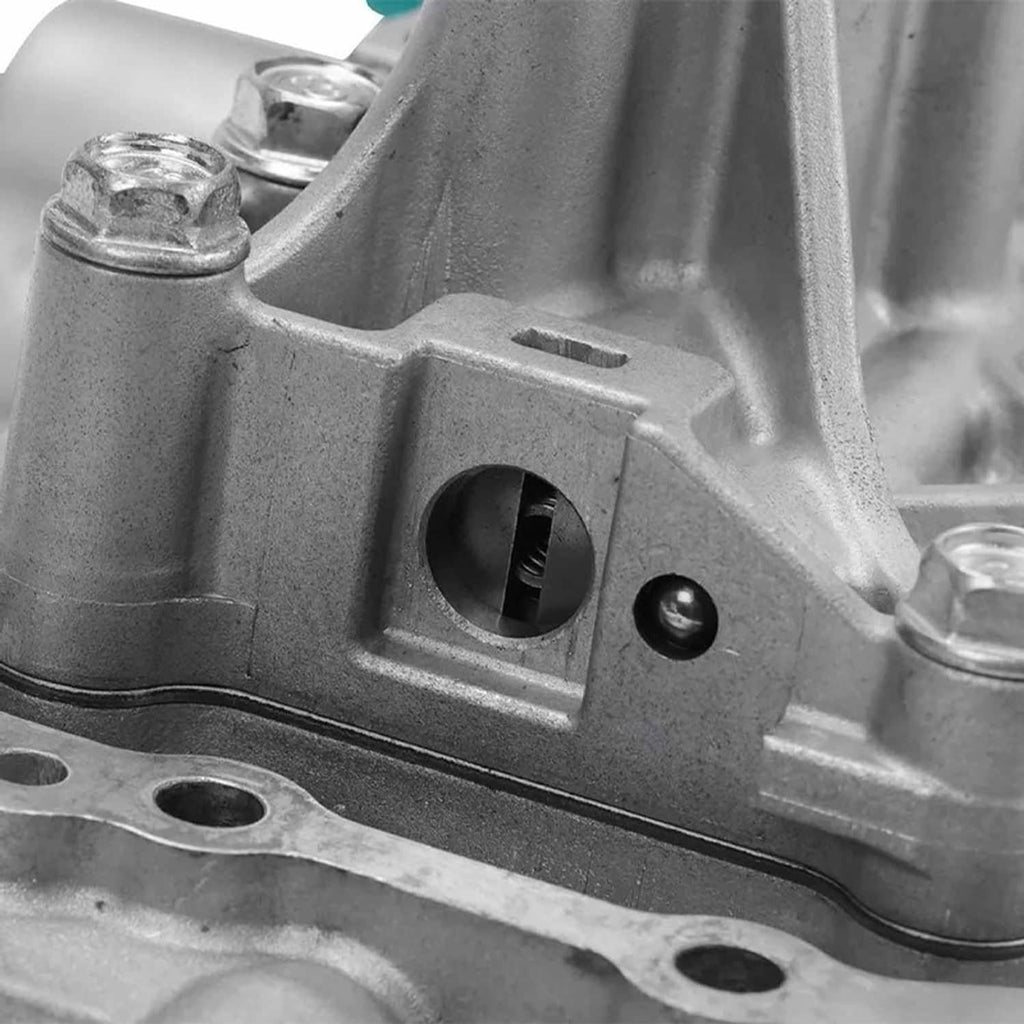Vehicle valve body assembly close-up of rectangular connector opening and mounting bolts