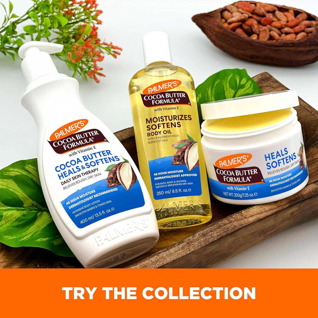 Cocoa butter lotion bottles and jar on wooden tray with cocoa beans and leaves