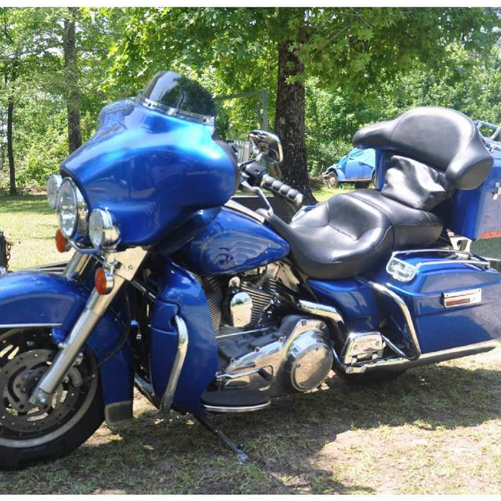 Black padded motorcycle seat with contoured rider backrest profile and seams.