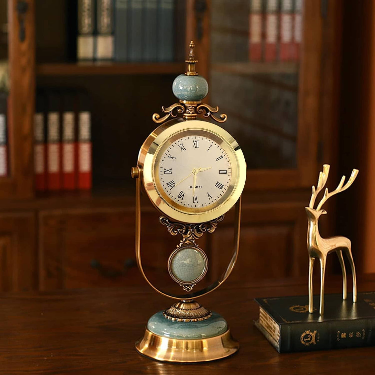 Mini quartz clock on ornate stand with gold case and Roman numeral face