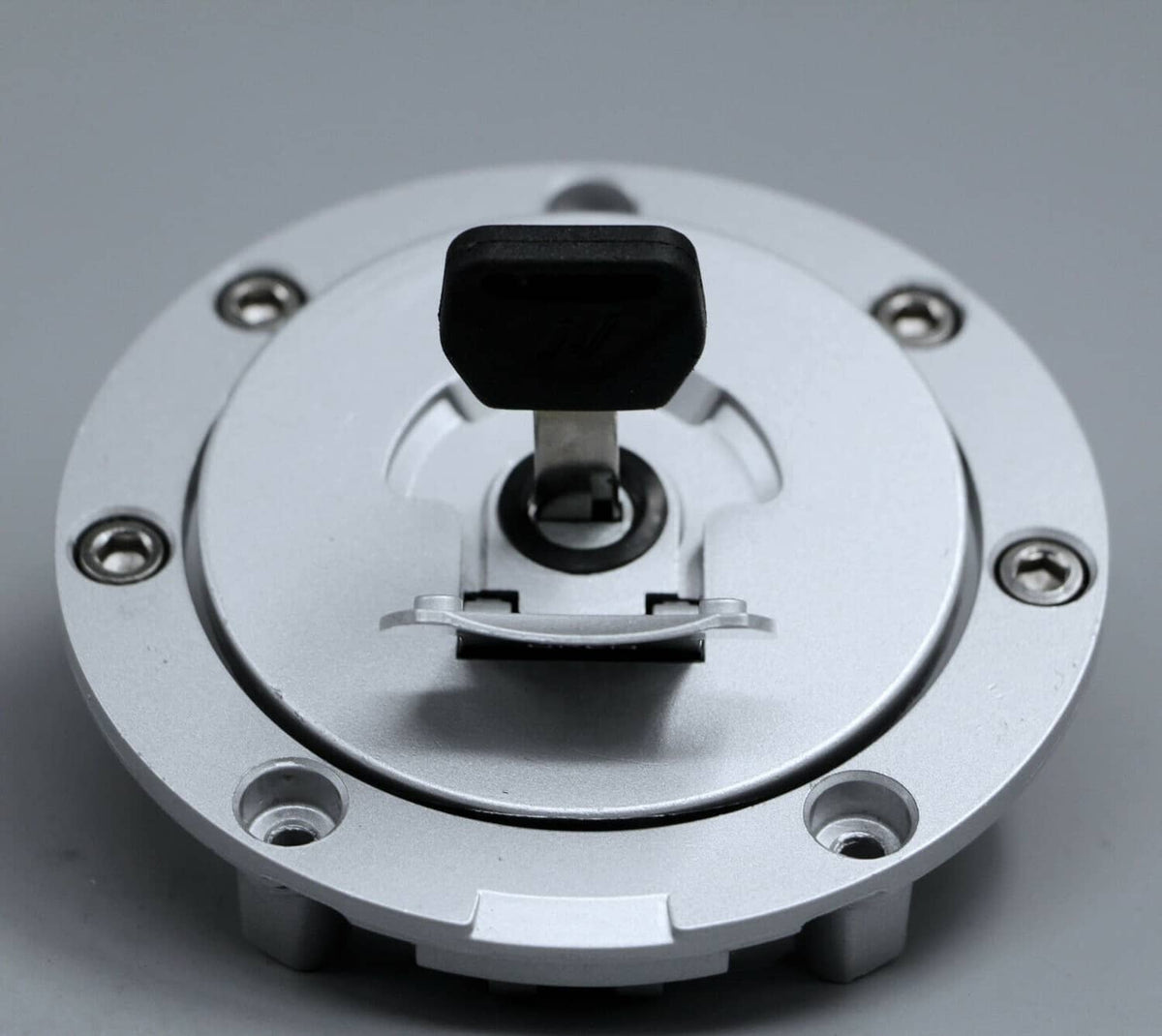 Fuel gas cap lock assembly with black cap cover and mounting bolts