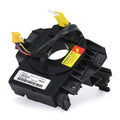 Black clock spring with steering angle sensor, yellow connectors, and warning label