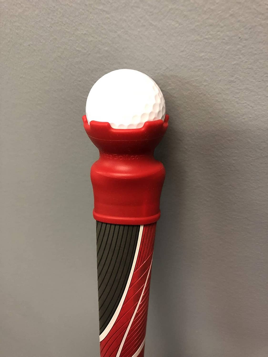 Red ball retriever with white ball on top and black ridged handle