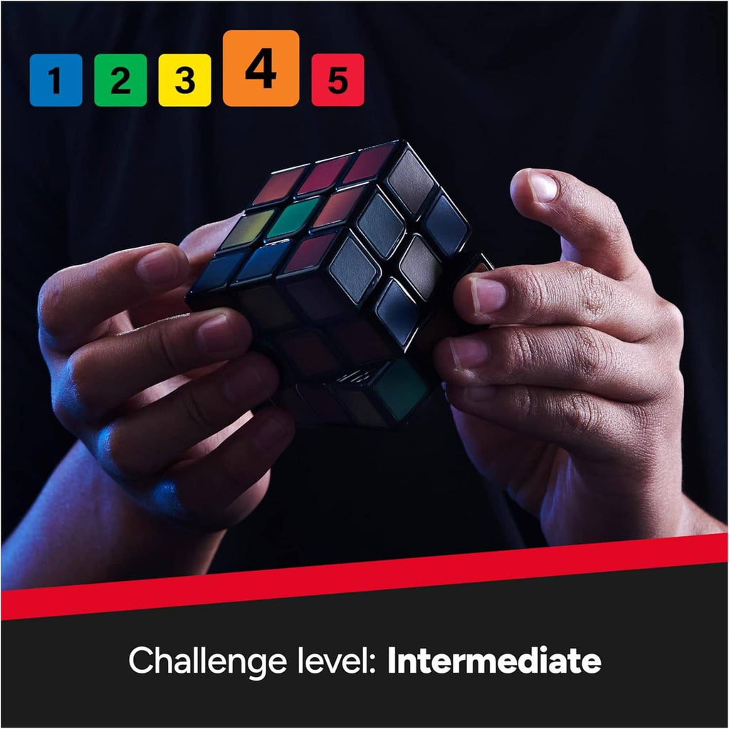 Hands holding 3x3 color-changing cube with green, yellow, and red tiles