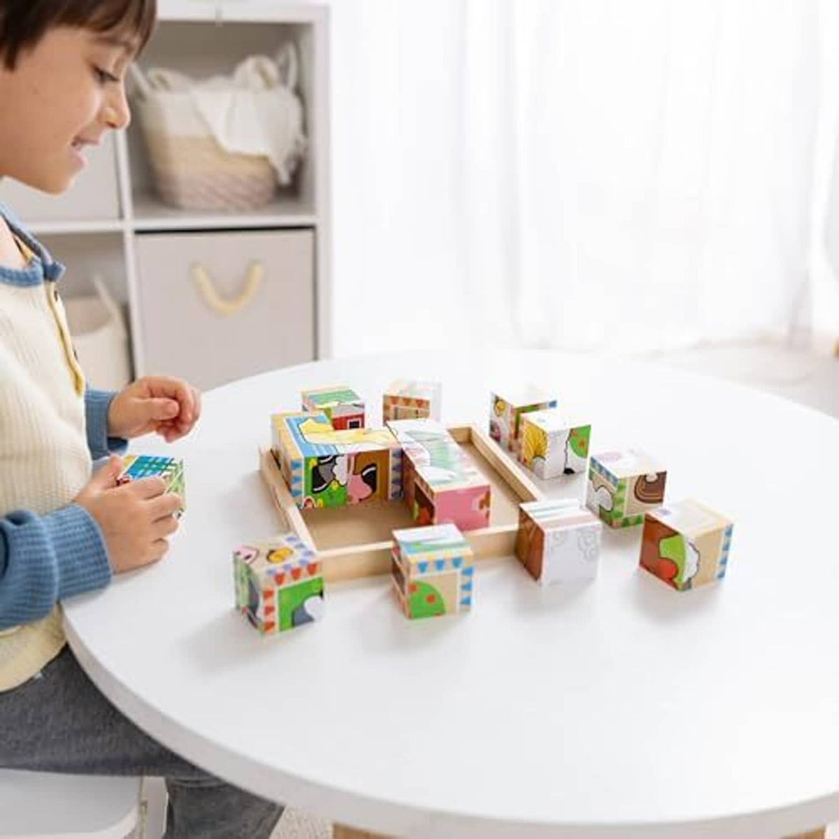 Kids’ wooden farm cube puzzle set on table with cubes arranged around the tray