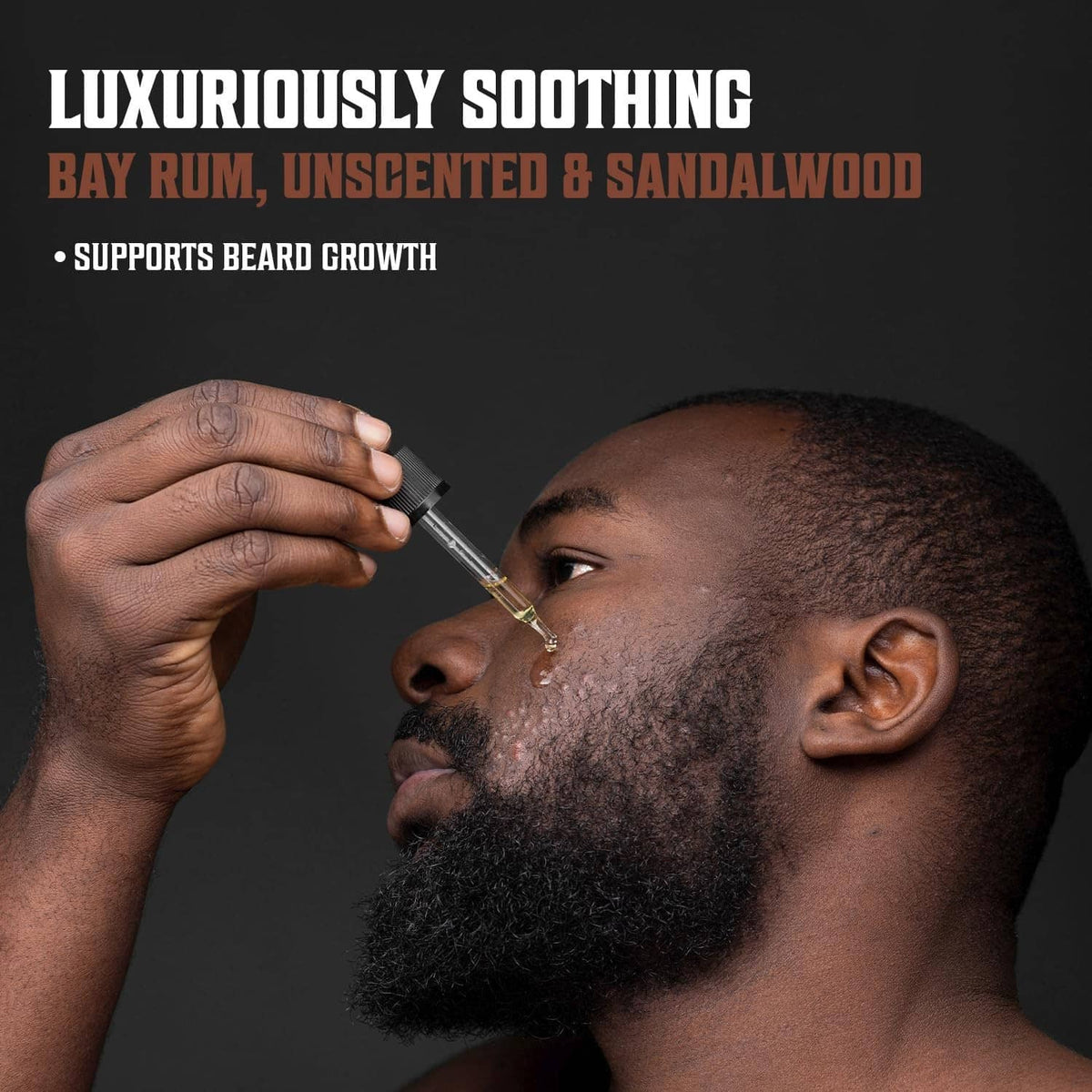 Beard oil dropper bottle with amber liquid, black cap and applicator nozzle